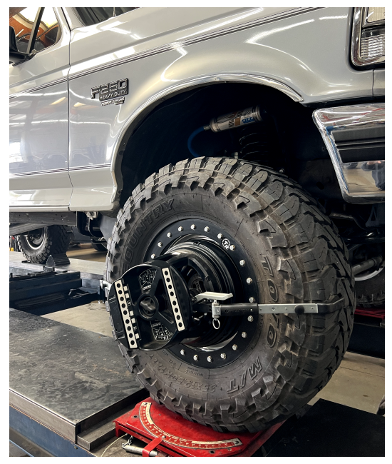 wheel alignment in Chino, CA at Domestic Diesel image of ford pickup truck on alignment machine in the shop