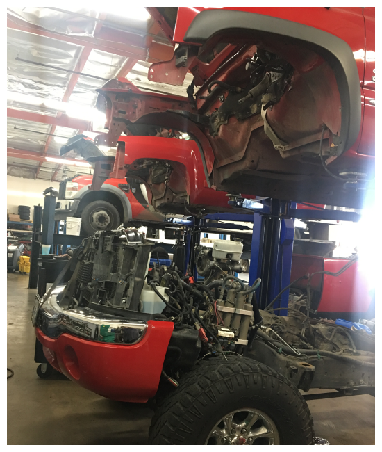 fleet maintenance and repair in Chino, CA at Domestic Diesel and Auto Services image of fleet of red trucks on lifts in shop bay