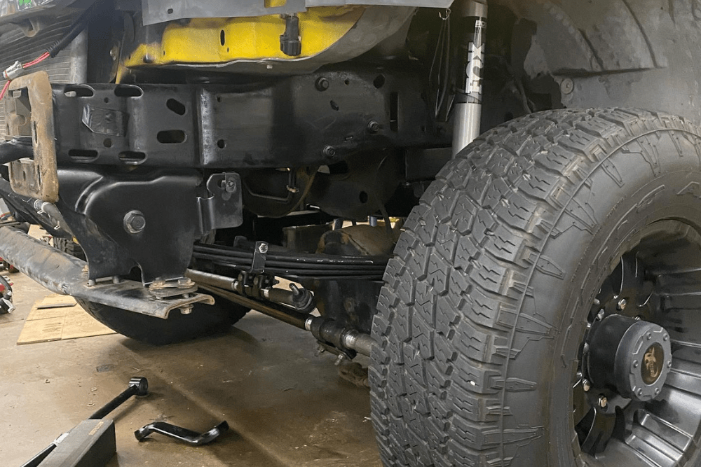 steering & suspension problems, diesel truck repair in Chino, CA at Domestic Diesel & Auto Service. Close-up of a lifted truck’s front suspension and steering system.