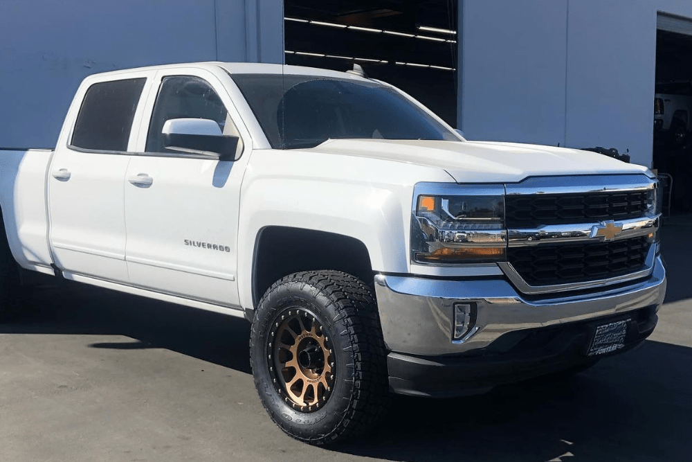 exhaust fluid quality poor, diesel truck repair in Chino, CA at Domestic Diesel & Auto Service. Image of a white Chevrolet Silverado parked outside the shop bay.